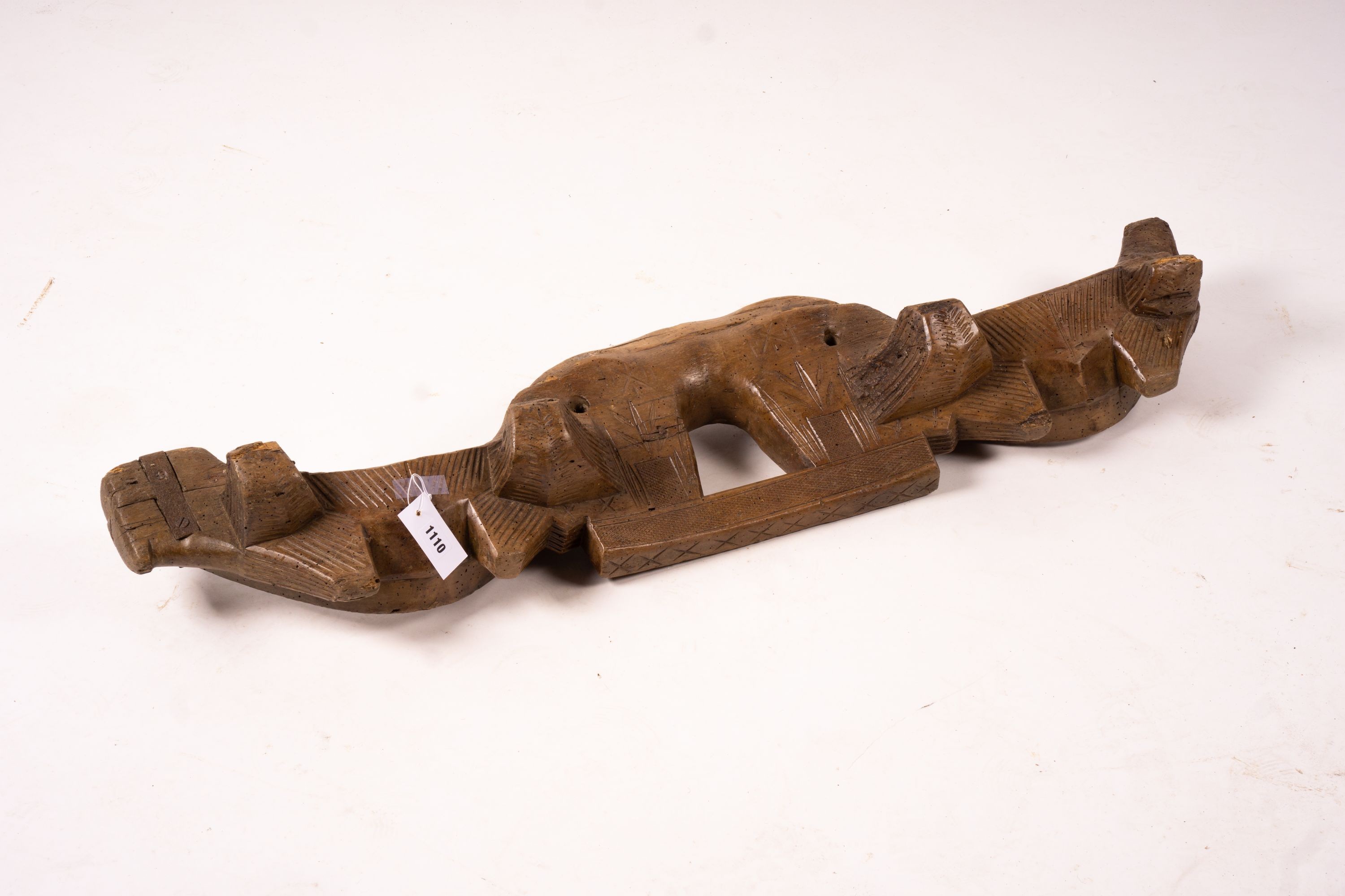 A 19th century Spanish carved fruitwood ox yoke, length 108cm